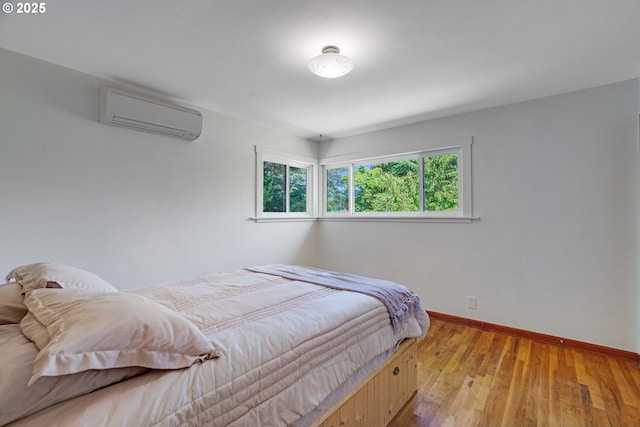 13015 E Burnside St, Portland, OR 97233 - bedroom with a wall mounted air conditioner and light wood-style flooring
