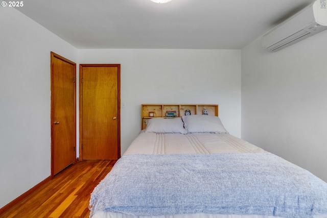13015 E Burnside St, Portland, OR 97233 - bedroom with an AC wall unit and wood finished floors