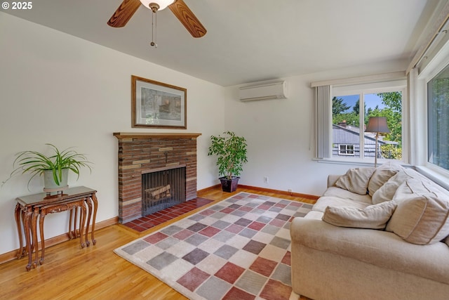 13015 E Burnside St, Portland, OR 97233 - living room with a wall mounted AC, wood finished floors, a fireplace with flush hearth, and ceiling fan