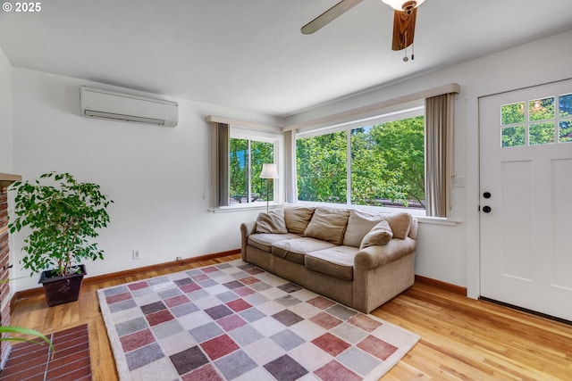 13015 E Burnside St, Portland, OR 97233 - living room featuring a wall unit AC, light wood-style flooring, healthy amount of natural light, and a ceiling fan