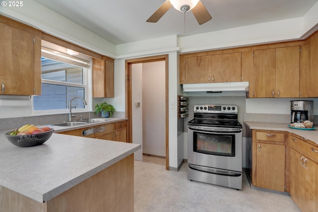 13015 E Burnside St, Portland, OR 97233 - kitchen with stainless steel electric range oven, under cabinet range hood, light countertops, ceiling fan, and brown cabinetry
