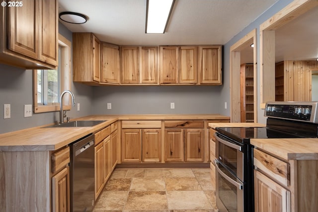 18898 Tuscarora Ln, Bend, OR 97702 - kitchen with stainless steel appliances, wooden counters, light stone finish flooring, and light brown cabinetry