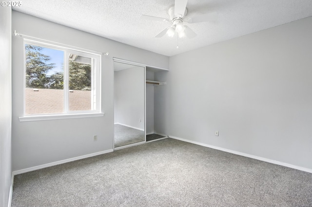 5594 SW Murray Blvd, Beaverton, OR 97005 - unfurnished bedroom featuring a closet, a textured ceiling, carpet, and multiple windows