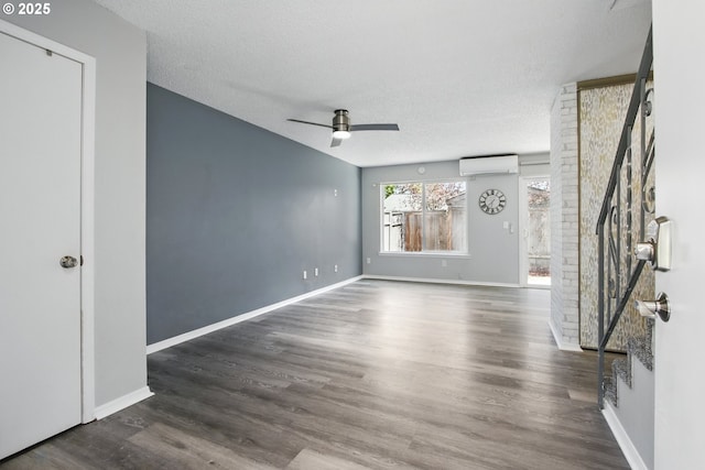5594 SW Murray Blvd, Beaverton, OR 97005 - unfurnished room with wood finished floors, baseboards, an AC wall unit, a textured ceiling, and a ceiling fan