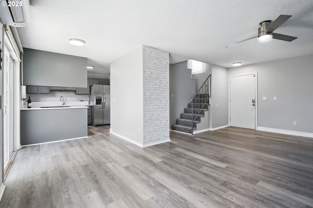 5594 SW Murray Blvd, Beaverton, OR 97005 - unfurnished living room featuring a sink, ceiling fan, a textured ceiling, and wood finished floors