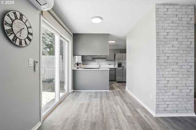 5594 SW Murray Blvd, Beaverton, OR 97005 - kitchen featuring light countertops, stainless steel refrigerator with ice dispenser, gray cabinetry, and wood finished floors
