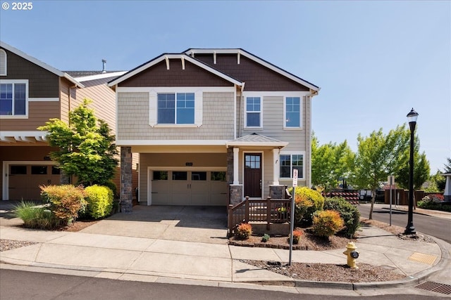 craftsman-style home with concrete driveway, stone siding, and a garage