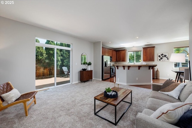 living room featuring recessed lighting, baseboards, visible vents, and light carpet