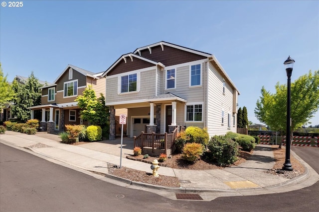 craftsman inspired home with fence, driveway, and stone siding