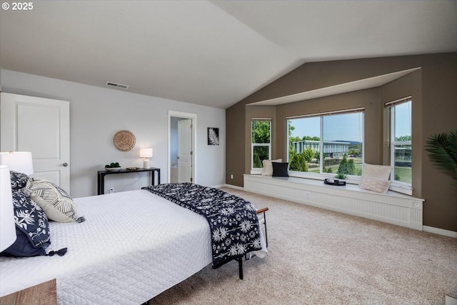 carpeted bedroom featuring visible vents, baseboards, and vaulted ceiling
