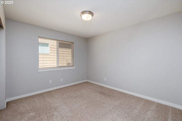 carpeted empty room with baseboards