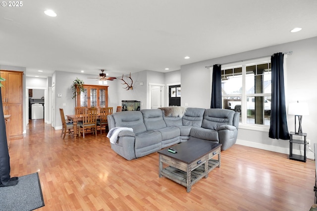 living room with ceiling fan and light wood-type flooring