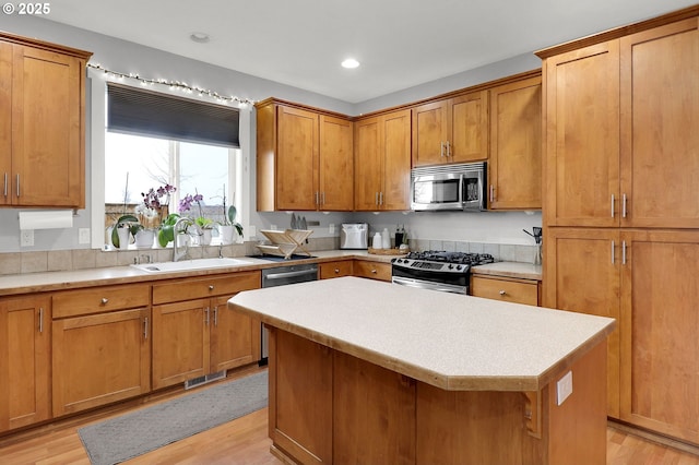 3730 Hemlock Pl SE, Albany, OR 97322 - kitchen with appliances with stainless steel finishes, a sink, light countertops, light wood finished floors, and recessed lighting