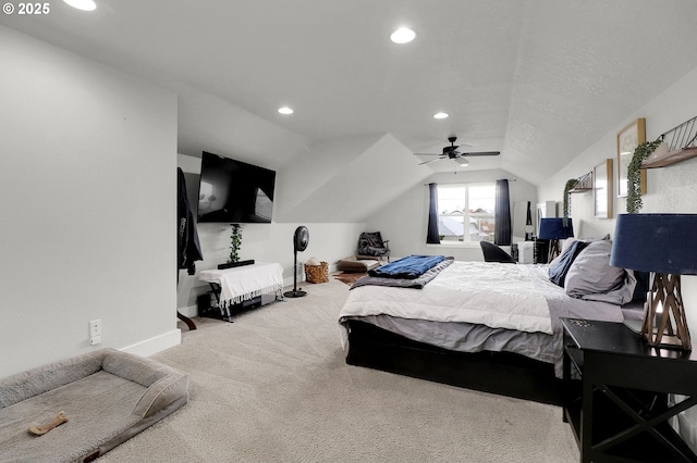 bedroom featuring vaulted ceiling, light colored carpet, and ceiling fan