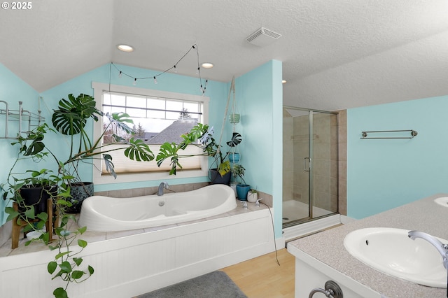 3730 Hemlock Pl SE, Albany, OR 97322 - bathroom with a shower stall, a textured ceiling, wood finished floors, a bath, and lofted ceiling