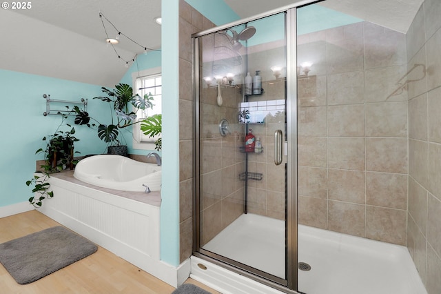 3730 Hemlock Pl SE, Albany, OR 97322 - bathroom featuring wood finished floors, vaulted ceiling, a stall shower, and a bath