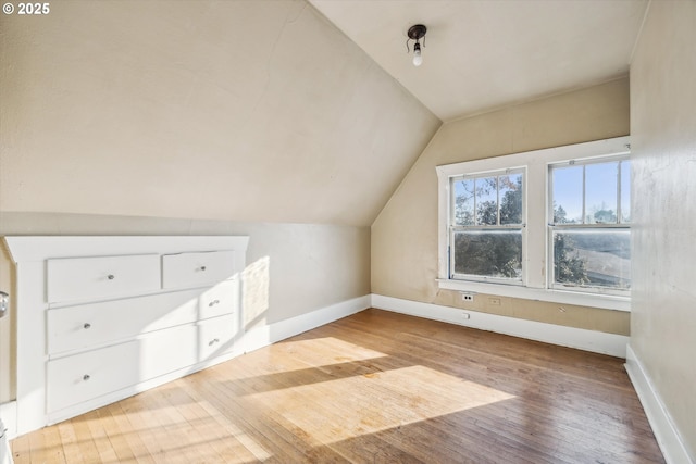 bonus room featuring lofted ceiling and light hardwood / wood-style floors