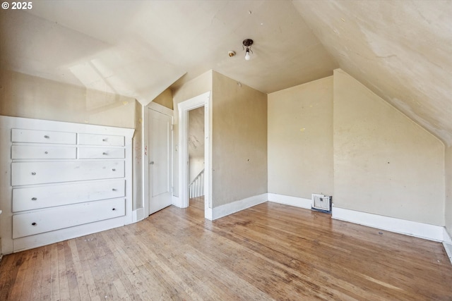 bonus room featuring vaulted ceiling and light hardwood / wood-style floors