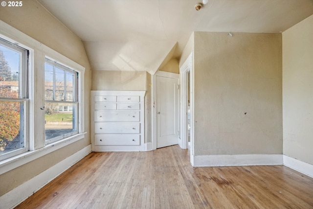 interior space with lofted ceiling and light hardwood / wood-style floors