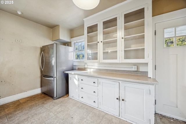 kitchen with white cabinetry and stainless steel refrigerator