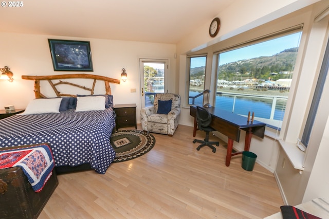 bedroom featuring a mountain view and light hardwood / wood-style floors