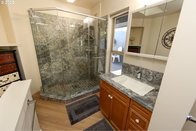 bathroom featuring a shower with door, vanity, and hardwood / wood-style floors