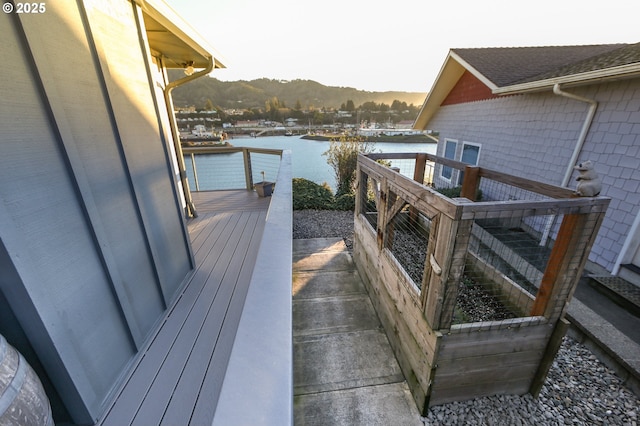 balcony featuring a deck with water view