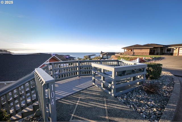 wooden deck featuring a water view