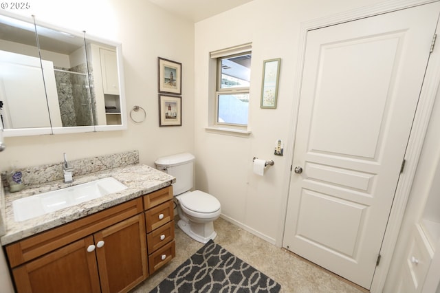 bathroom with vanity, toilet, and walk in shower