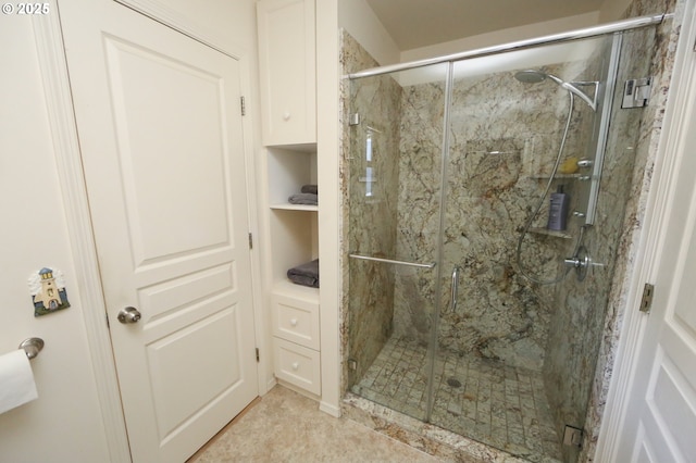 bathroom with tile patterned floors and an enclosed shower