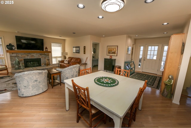 dining area featuring a fireplace and light hardwood / wood-style floors