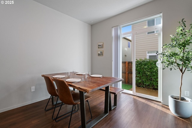 dining space with dark wood-type flooring