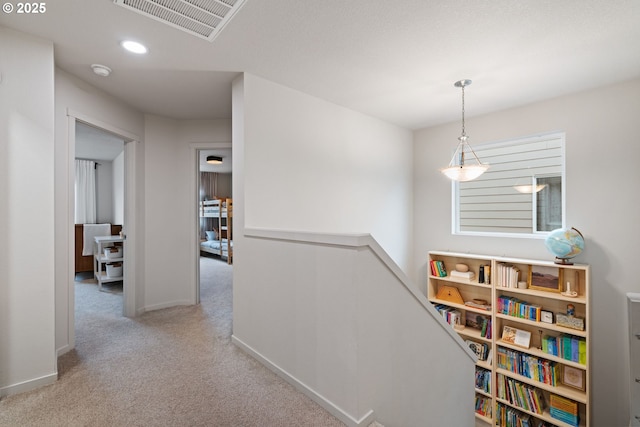 hallway with light colored carpet