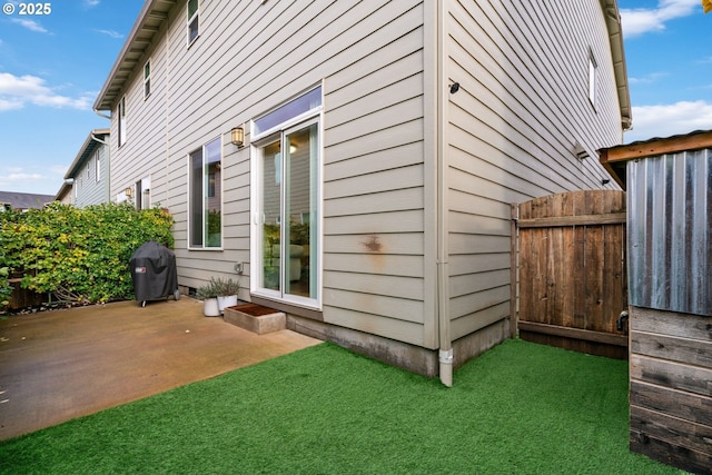 view of side of property featuring a patio area and a yard