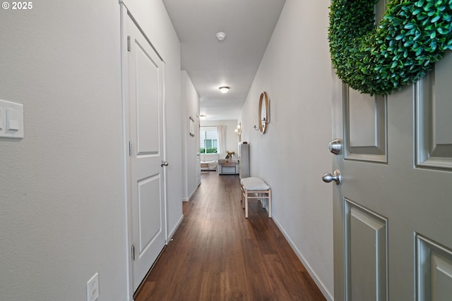 corridor featuring dark hardwood / wood-style flooring