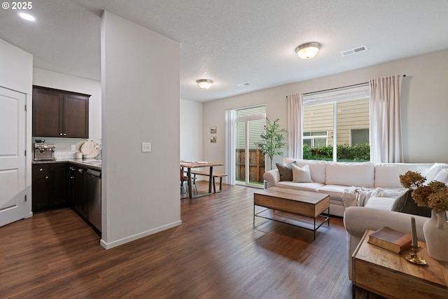 living room featuring dark hardwood / wood-style flooring and a textured ceiling