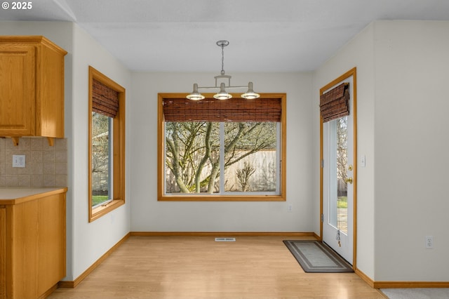 dining room featuring a chandelier and light wood-type flooring