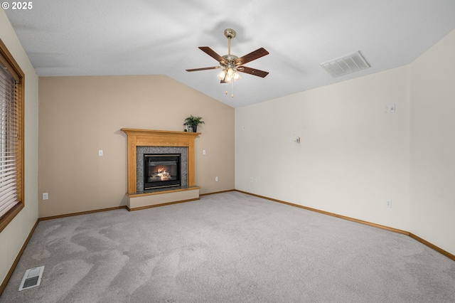 unfurnished living room featuring ceiling fan, vaulted ceiling, and light carpet