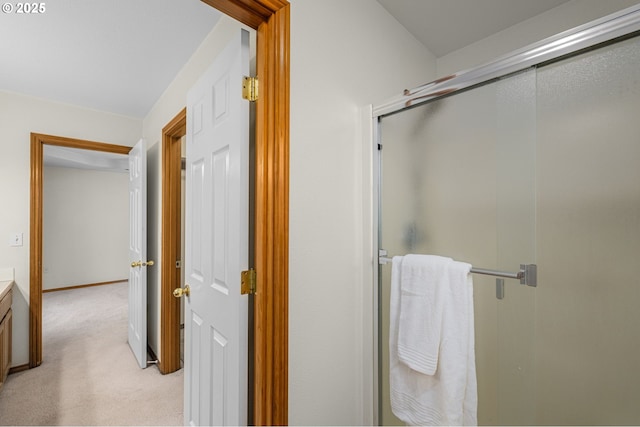 bathroom with a shower with door and vanity