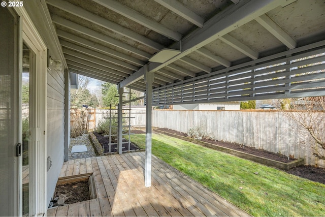 wooden deck featuring a lawn