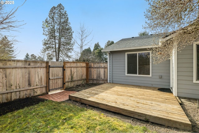 wooden terrace featuring a lawn