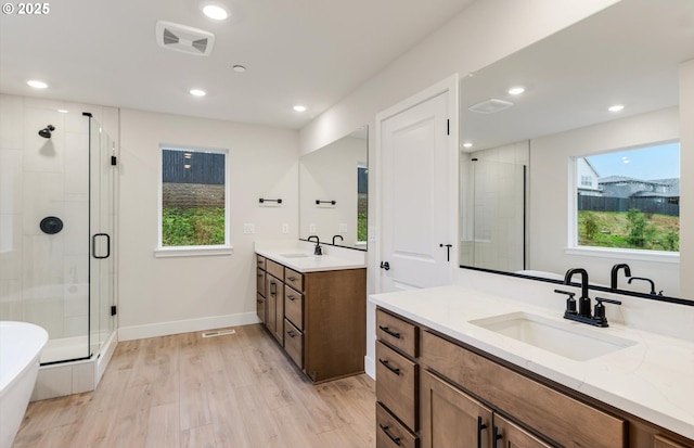 366 S 87th Ave, Ridgefield, WA 98642 - bathroom featuring a stall shower, healthy amount of natural light, wood finished floors, two vanities, and recessed lighting