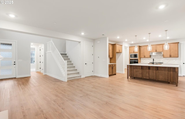 366 S 87th Ave, Ridgefield, WA 98642 - kitchen featuring built in microwave, black oven, open floor plan, light countertops, and recessed lighting