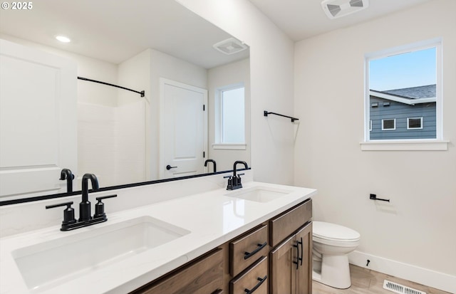 366 S 87th Ave, Ridgefield, WA 98642 - bathroom with baseboards, toilet, double vanity, a shower, and wood finished floors