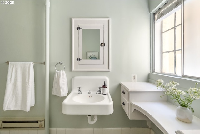 2829 SE Belmont St Unit 205, Portland, OR 97214 - bathroom featuring a baseboard heating unit and healthy amount of natural light