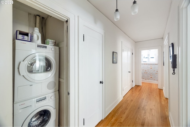 2829 SE Belmont St Unit 205, Portland, OR 97214 - laundry room with stacked washer / drying machine and light wood finished floors