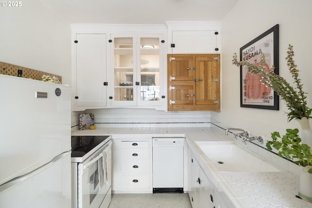2829 SE Belmont St Unit 205, Portland, OR 97214 - kitchen with white appliances, white cabinetry, glass insert cabinets, and tile countertops