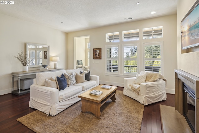 10135 SW Morrison St, Portland, OR 97225 - living area with a textured ceiling, dark wood finished floors, a glass covered fireplace, baseboards, and recessed lighting