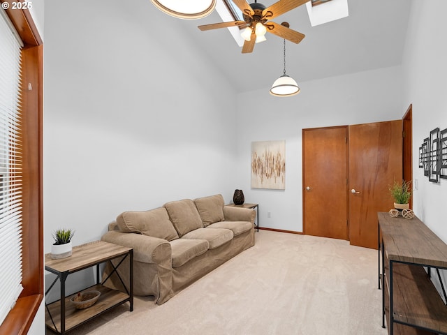 living room with high vaulted ceiling, ceiling fan, and carpet flooring