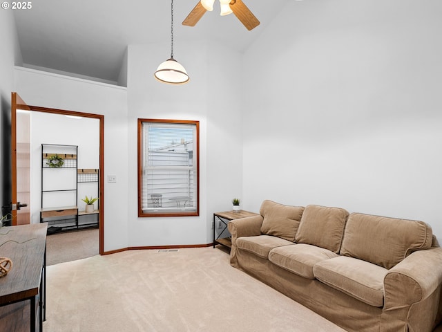 living room featuring high vaulted ceiling, ceiling fan, and light carpet